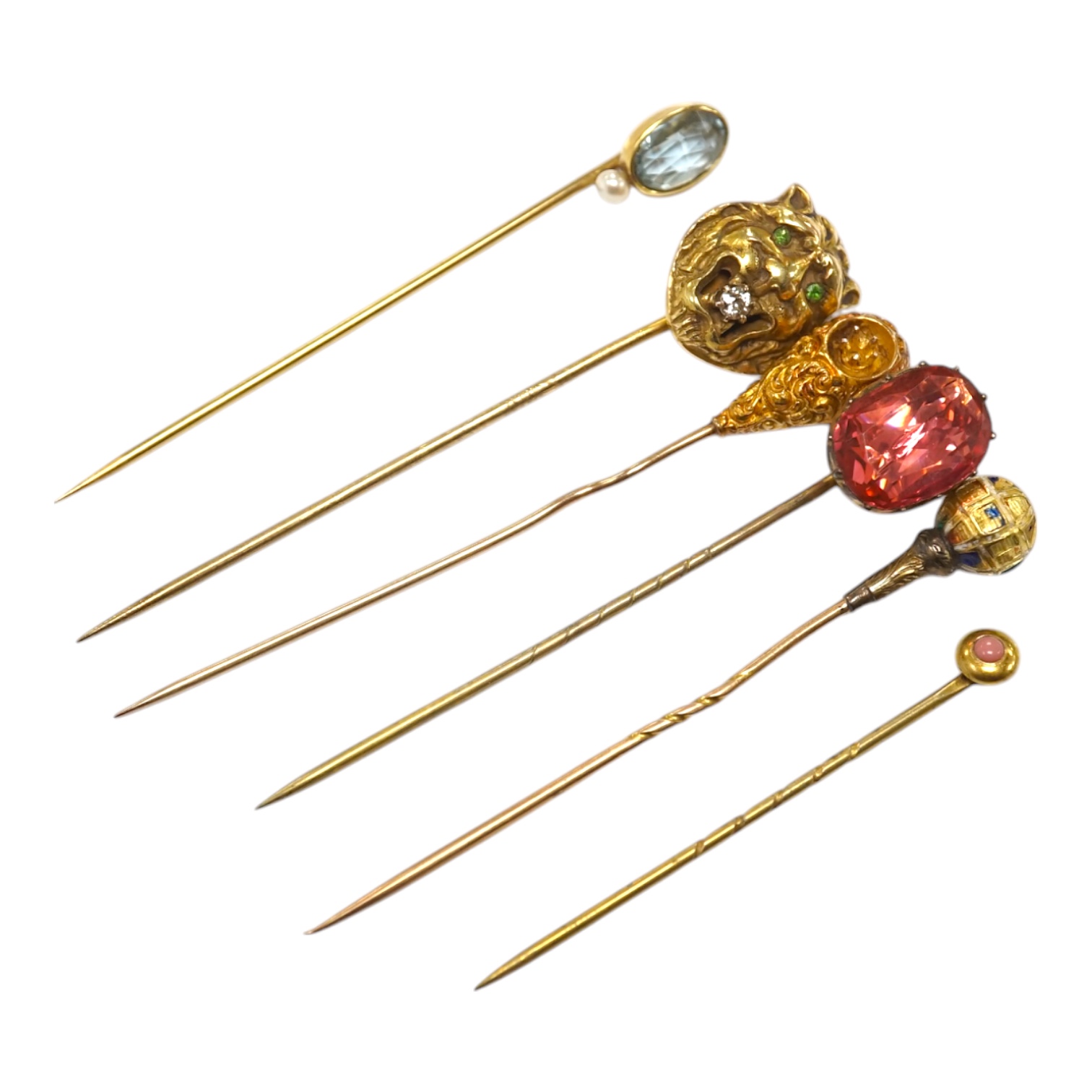 A collection of six assorted mainly early 20th century stick pins including tiger's head set with diamond and green garnets, 68mm. Condition - poor to fair